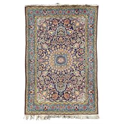 Persian indigo ground rug, overall arabesque design, central multi-point medallion surrounded by scrolling leafy branches and palmettes, the border decorated with repeating stylised plant motifs within guard stripes 