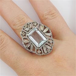 Large silver aquamarine and diamond pierced design ring, the central emerald cut aquamarine of approx 3.75 carat, with baguette and round brilliant cut diamond surround, total diamond weight approx 1.75 carat