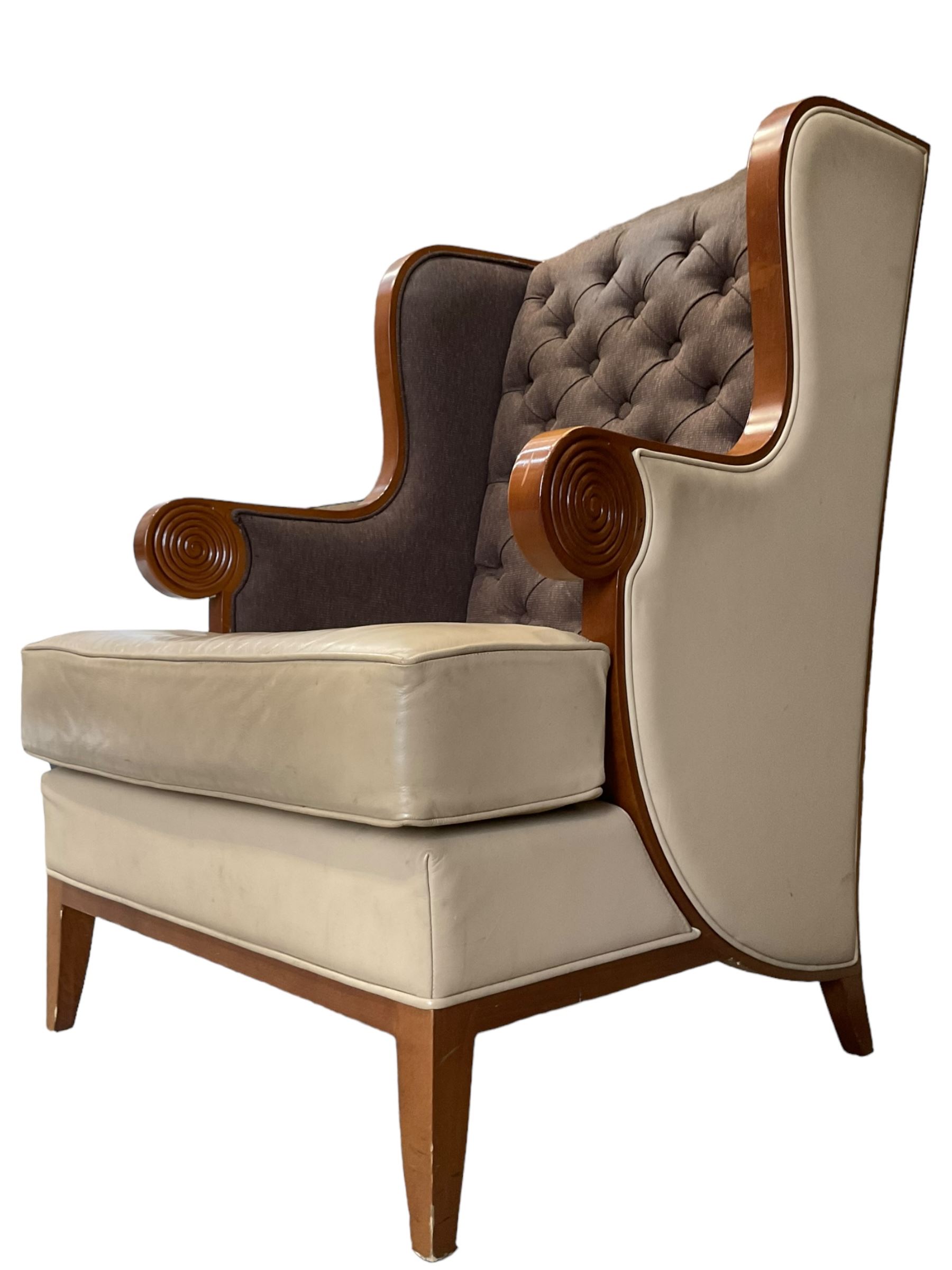 Walnut finish framed wing back armchair upholstered leather and buttoned fabric