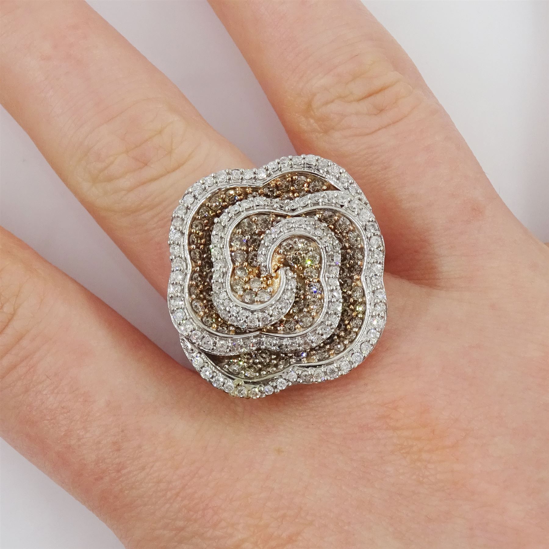 White gold round brilliant cut white and fancy light brown colour diamond rose swirl ring, hallmarked 9ct, total diamond weight approx 1.50 carat