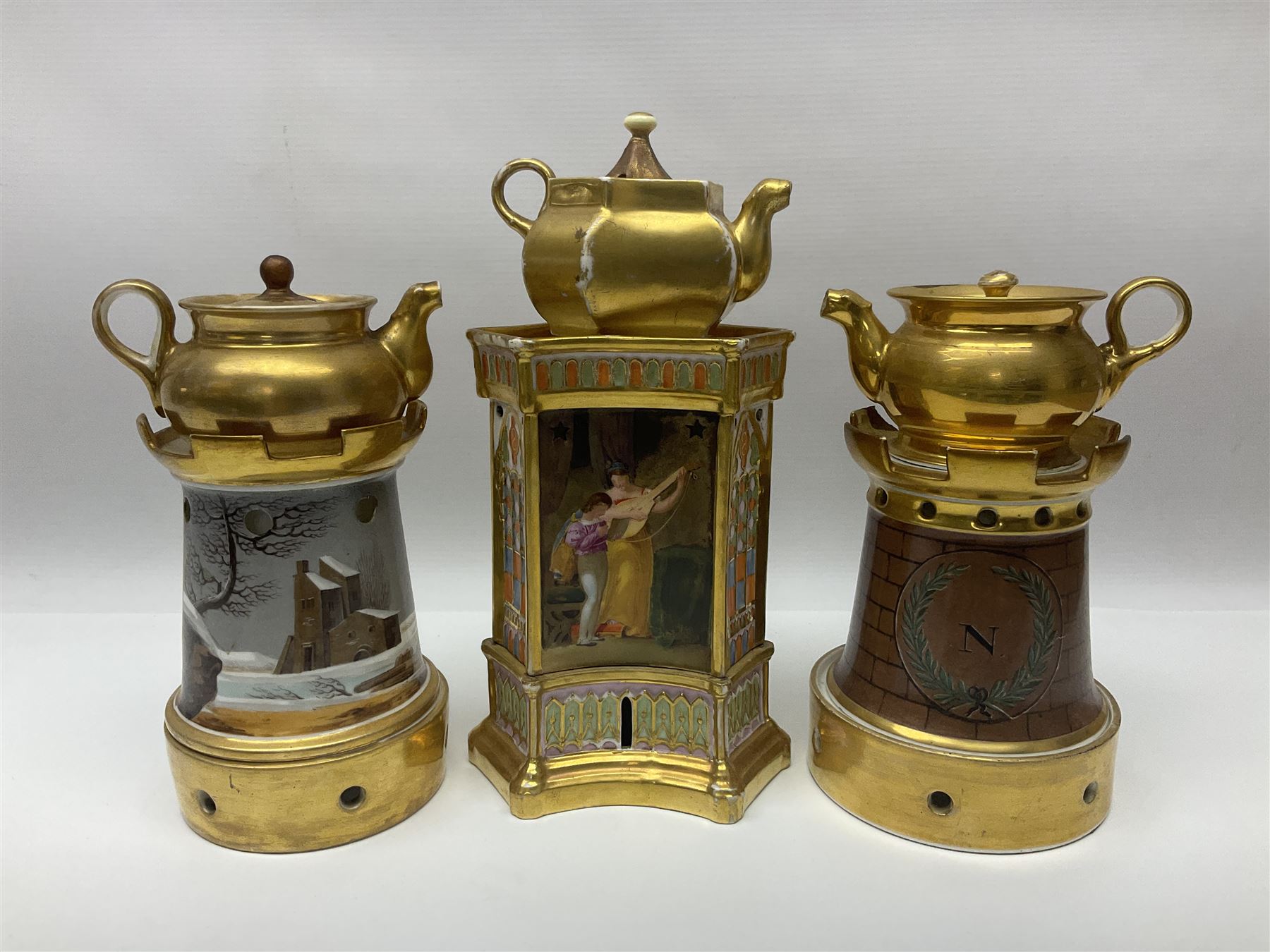 Three 19th century continental teapots and warmers, the first teapot upon a hexagonal warming base, painted with figures in period dress, the second pained with Neapolitan and the third decorated with landscapes, largest H28cm 