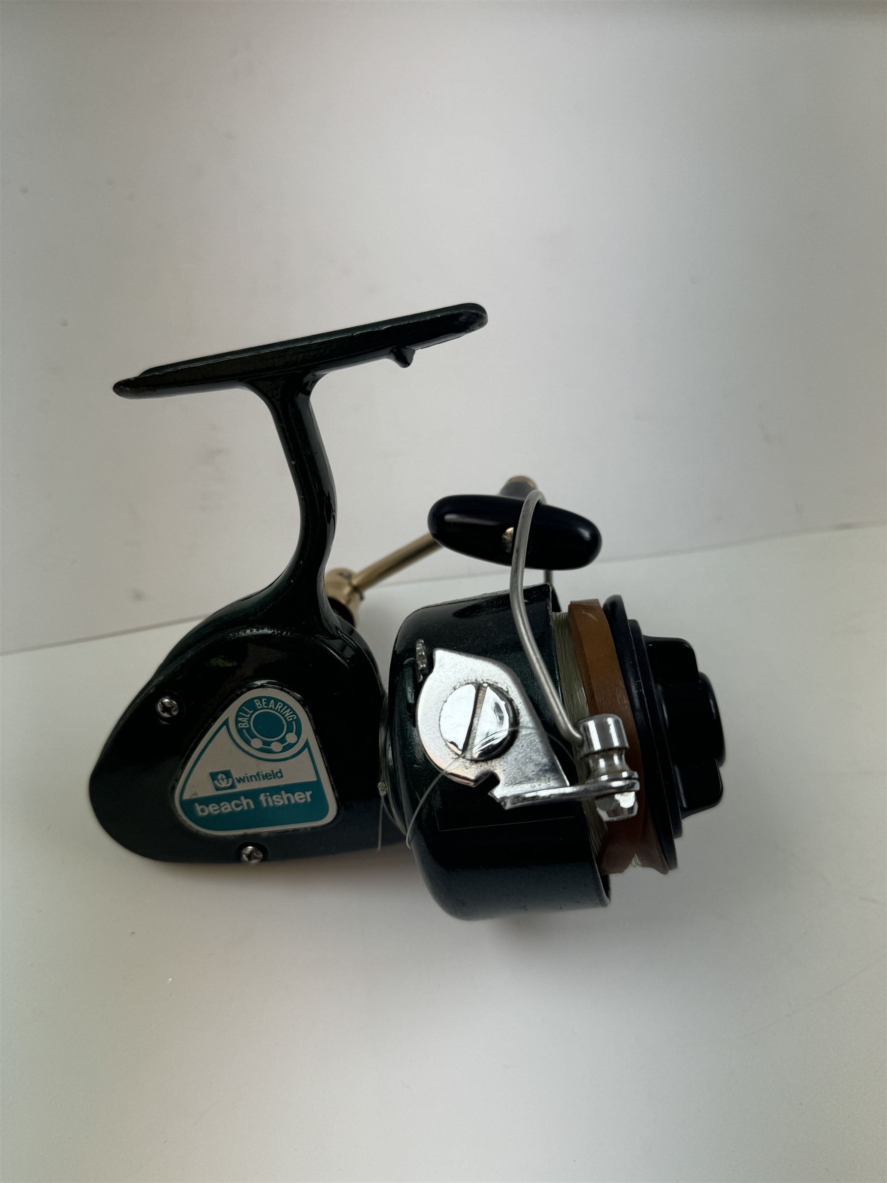 Four fishing reels, Winfield Beach fisher rod, Winfield International 20 , DAM International etc 