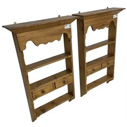 Pair of 20th century small waxed pine plate racks, shaped apron over three shelves and single drawer styled as two