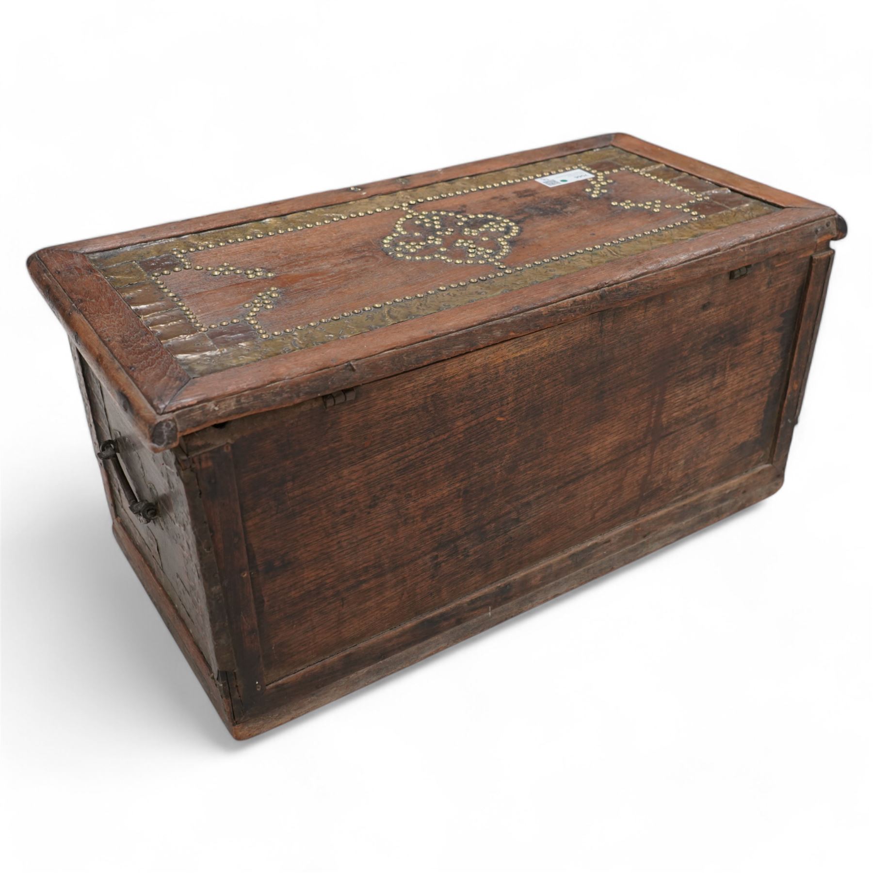 19th century Zanzibar teak and brass mounted chest, hinged lid enclosing divisions, the front decorated with studwork, carrying handles to each side 