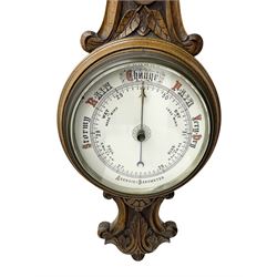 Edwardian - carved oak aneroid barometer, with a rounded top carved with scroll work, 8