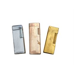 Dunhill gold plated lighter with engine turned decoration, with two other lighters