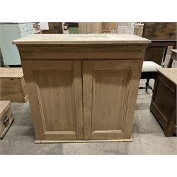 Stripped pine cupboard or bookcase, projecting cornice over two panelled doors, enclosing two shelves - THIS LOT IS TO BE COLLECTED BY APPOINTMENT FROM THE OLD BUFFER DEPOT, MELBOURNE PLACE, SOWERBY, THIRSK, YO7 1QY