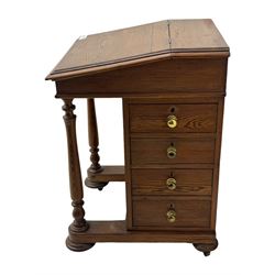 19th century pitch pine Davenport desk, sloping hinged top, fitted with four drawers, on turned column supports, turned compressed feet with castors 