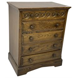 Mid-20th century oak chest, fitted with five drawers, the top drawer carved with flower head roundels, on bracketed plinth base 