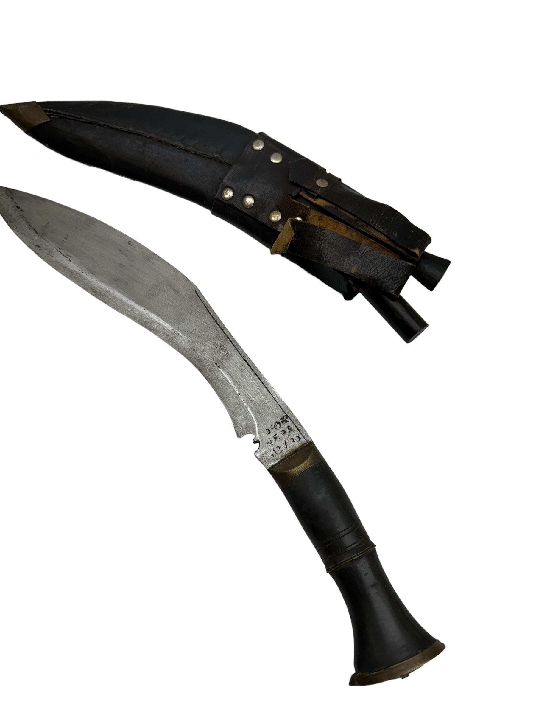 British Service issued Kukri, circa 1980s, with curving blade, hardwood and brass grip in leather covered scabbard with two skinning knives, blade, stamped 12th  December 1980 Dharan Nepal to blade, blade L28cm, overall L39cm