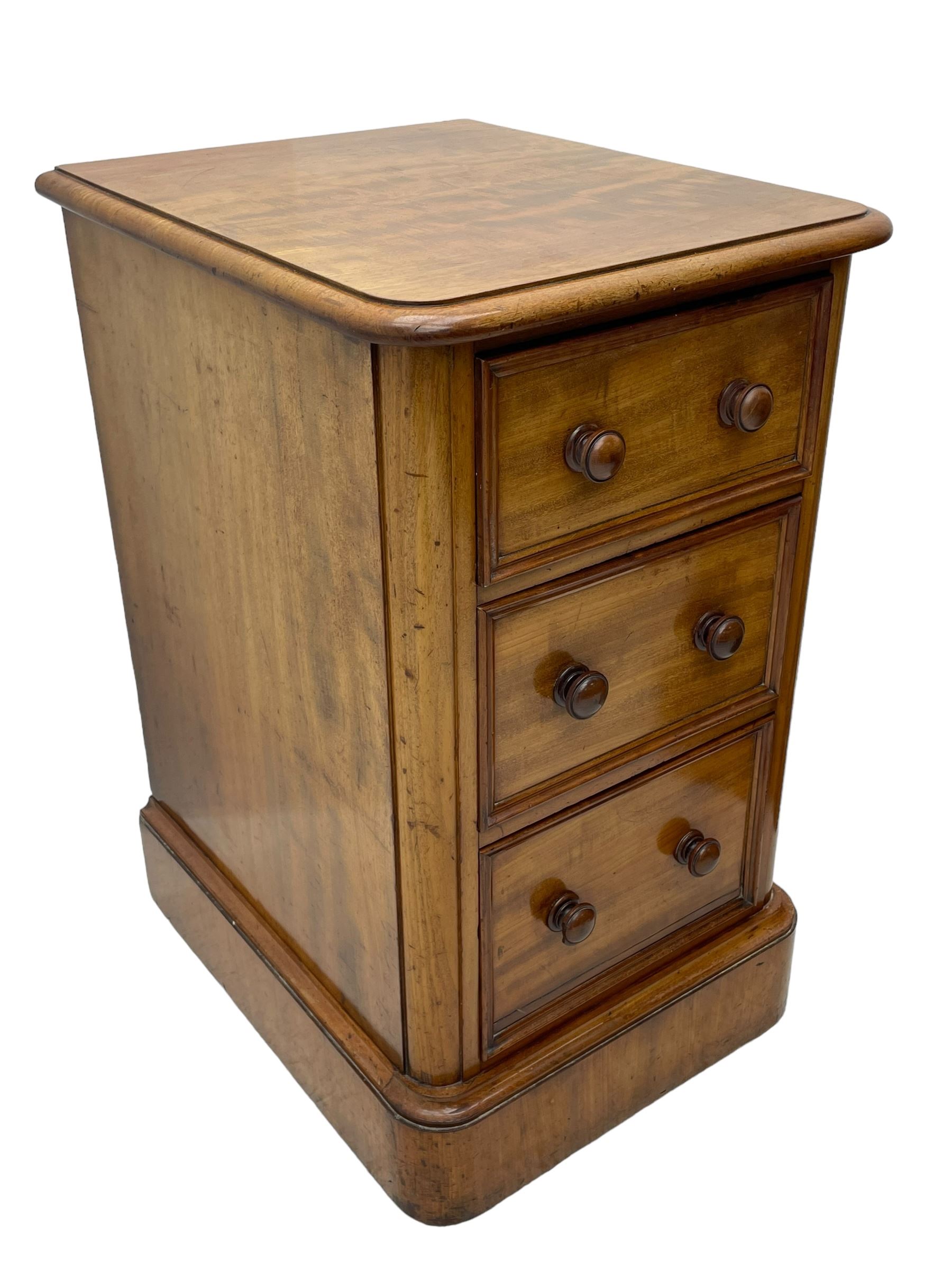 Pair of Victorian figured mahogany pedestal chests, rectangular form with rounded front corners, moulded top over three drawers with applied mouldings and turned handles, on moulded plinth base