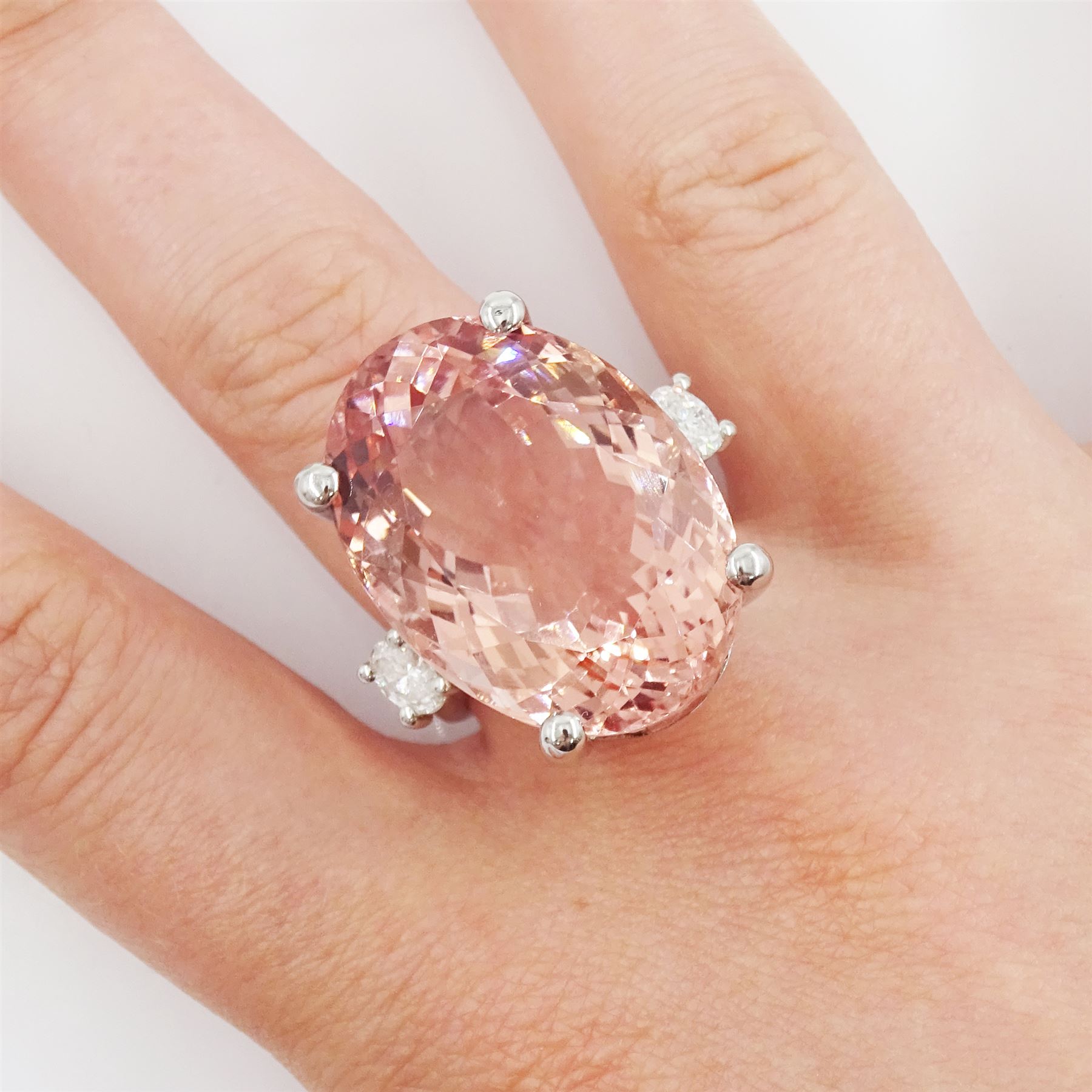 Platinum three stone large oval cut morganite and oval cut diamond ring, hallmarked, morganite 33.80 carat, total diamond weight 0.60 carat, with World Gemological Institute report