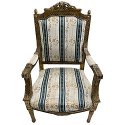 Late 20th century French design carved giltwood armchair, the cresting rail carved with scrolled foliage over foliate carved platform, upholstered in striped fabric decorated with trailing foliage and flower heads, acanthus carved arm terminals and upright supports, on turned and fluted supports 