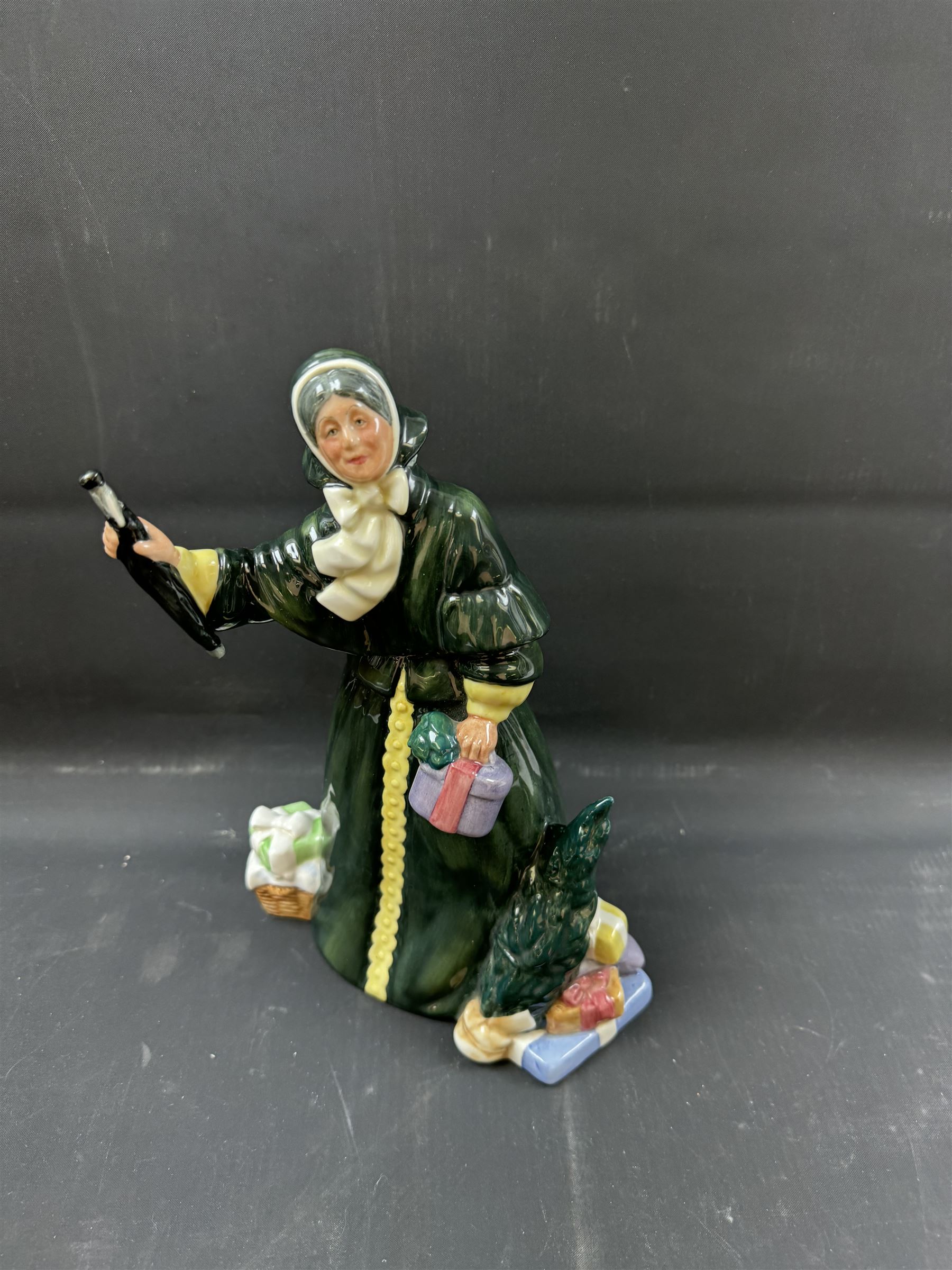 Four Royal Doulton figures, comprising The Parson's Daughter HN564, Dorothy HN3098, Christmas Parcels HN2851 and Biddy Pennyfarthing HN1843