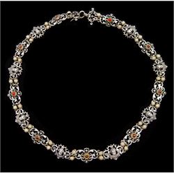 Early 20th century continental silver scroll link necklace, alternate panels of winged cherub and silver-gilt cabochon red paste stones, separated by silver-gilt flower head links, indistinct hallmarks, possibly Austrian or German