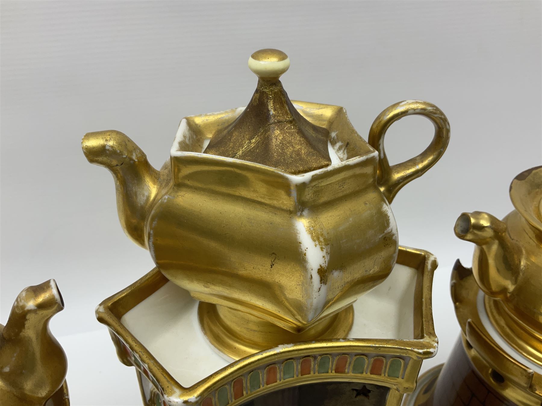 Three 19th century continental teapots and warmers, the first teapot upon a hexagonal warming base, painted with figures in period dress, the second pained with Neapolitan and the third decorated with landscapes, largest H28cm 