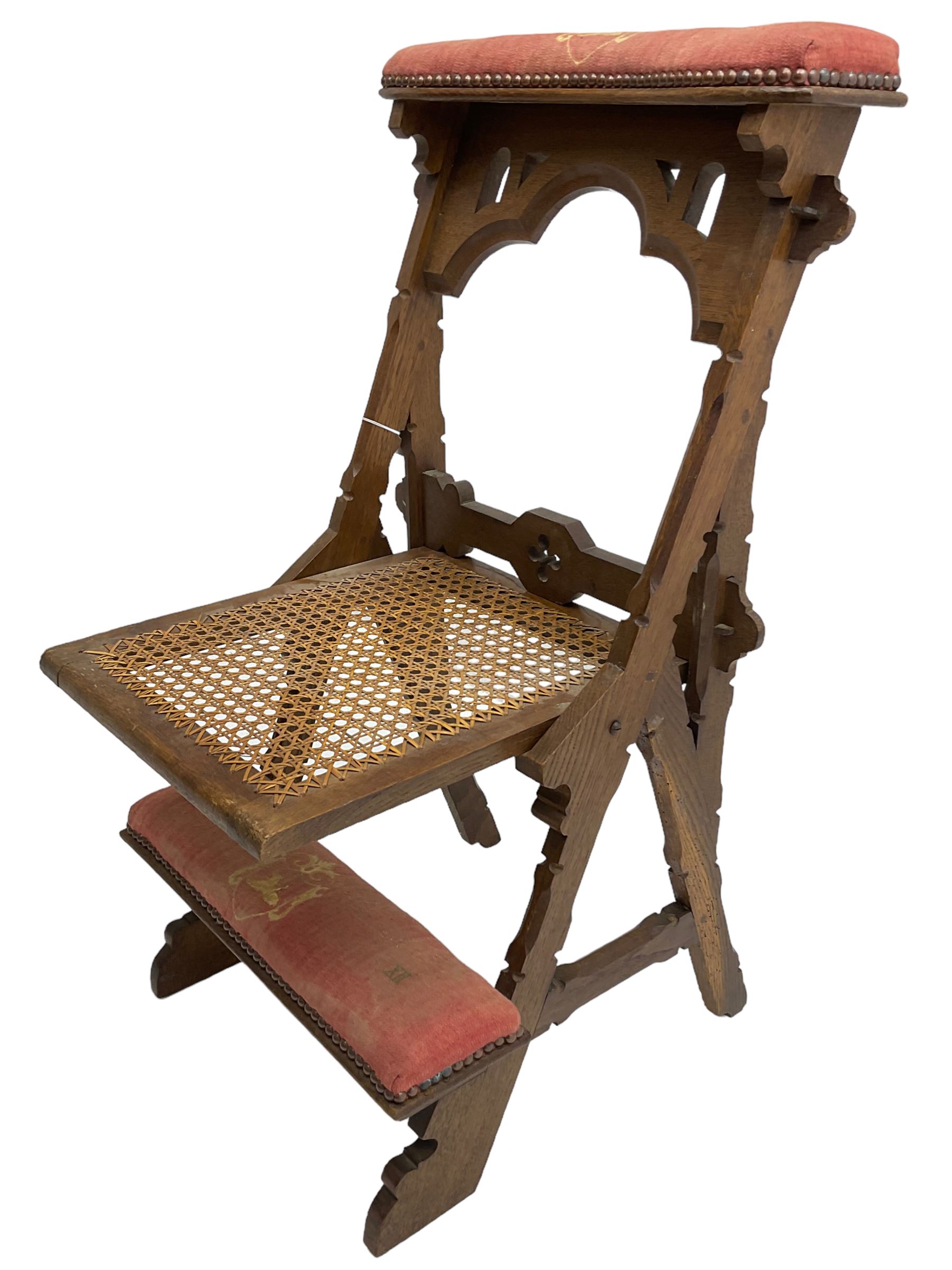 Late Victorian oak metamorphic prie-dieu chair, ecclesiastical design with pegged construction, upholstered kneel rest and top rest, hinged cane work seat