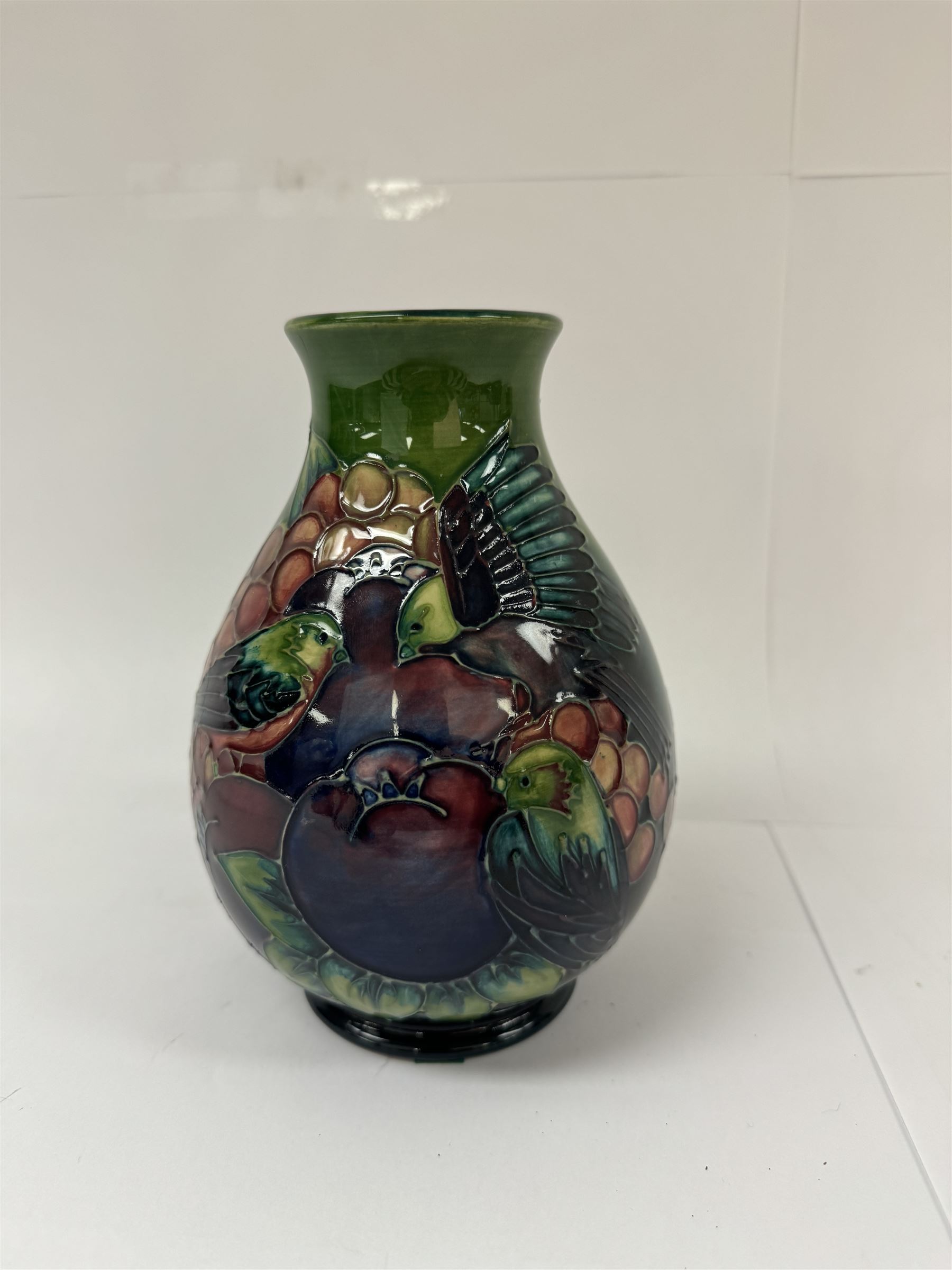 Moorcroft vase of baluster decorated in the Finches pattern with green ground, designed by Sally Tuffin, with makers mark beneath, H20cm