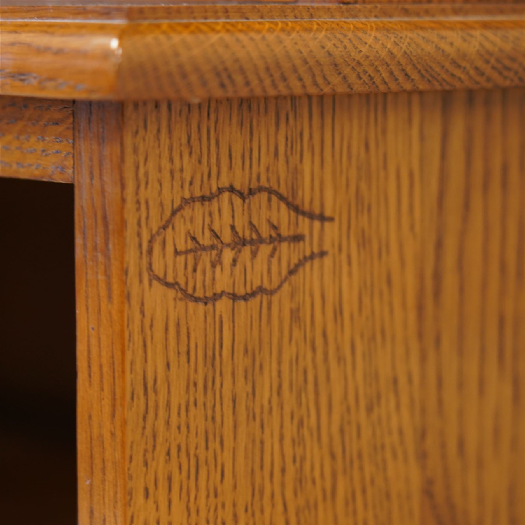 Light oak two-sectional bookcase, projecting moulded cornice over five adjustable shelves, carved with oak leaf motif 