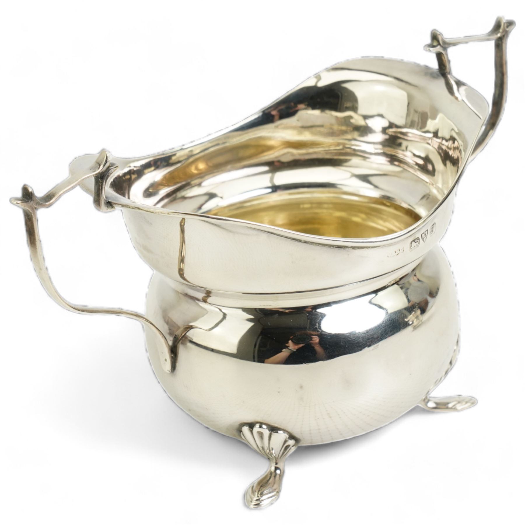  Victorian silver rectangular sugar basket with swing handle decorated with garlands and foliage on ball feet W15cm Sheffield 1891 Maker James Dixon & Son and a silver cream jug and sugar bowl Chester 1919 