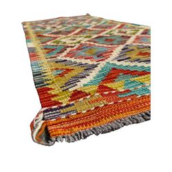 Chobi Kilim ground runner, the field decorated with a geometric pattern of coloured diamonds and triangles, each containing stylised motifs, the shorter ends enclosed by a plain border, and the longer sides with a multicoloured border

