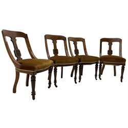 Set of four late Victorian walnut dining chairs, carved with stylised floral decoration and scrolling branches, upholstered seat, on turned and fluted supports 