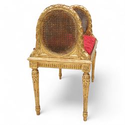 Late 19th century gilt wood and gesso window seat, raised oval cane work sides with lattice and ribbon decorated frame, rectangular cane work seat with upholstered squab cushion, moulded edge over fluted seat rails, on acanthus carved and stop-fluted turned supports 