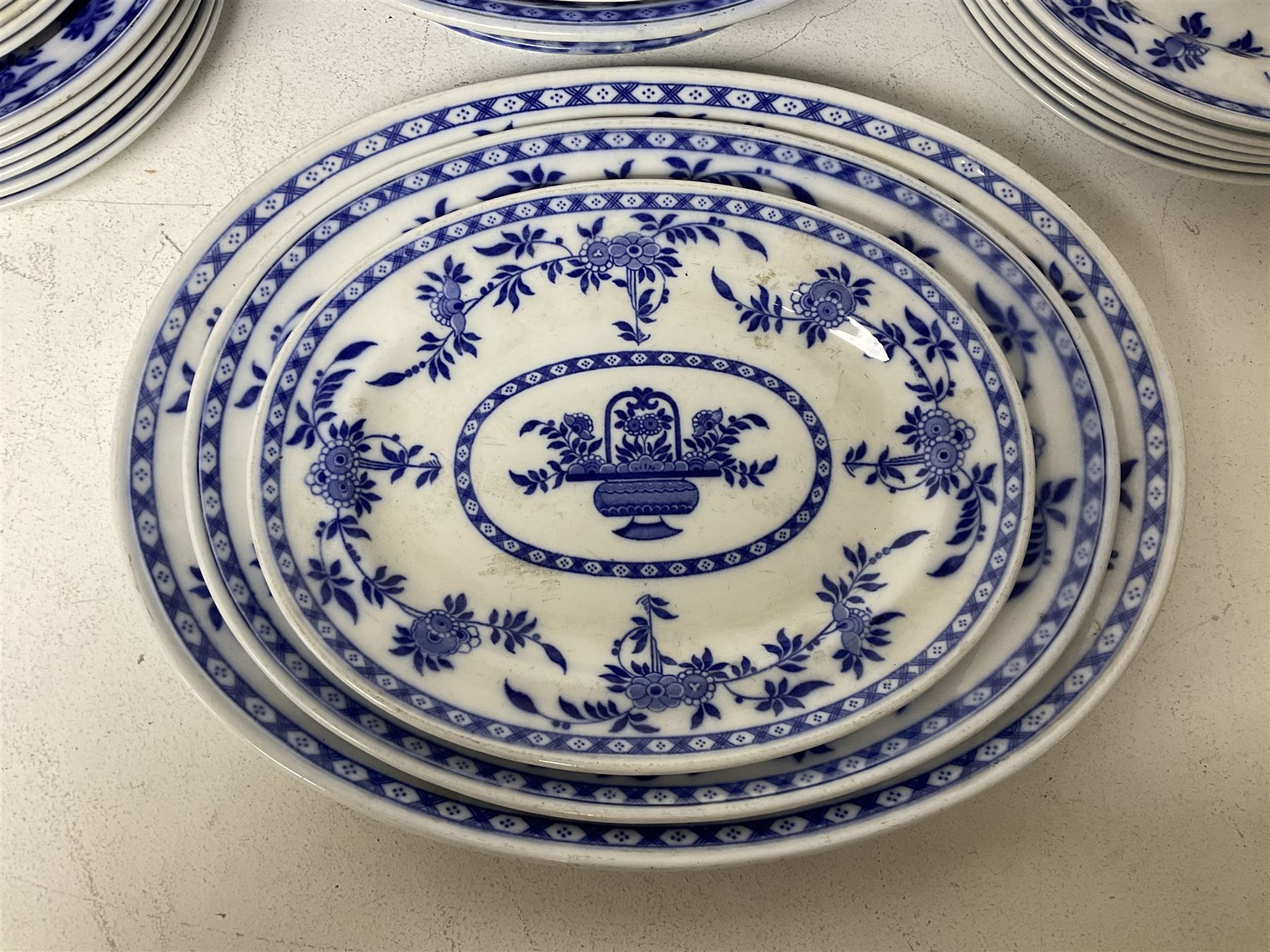 Mintons Delft blue and white dinner wares, to include three graduating oval platters, six dinner plates, six dessert plates and six side plates, tureen with cover and two sauce boats