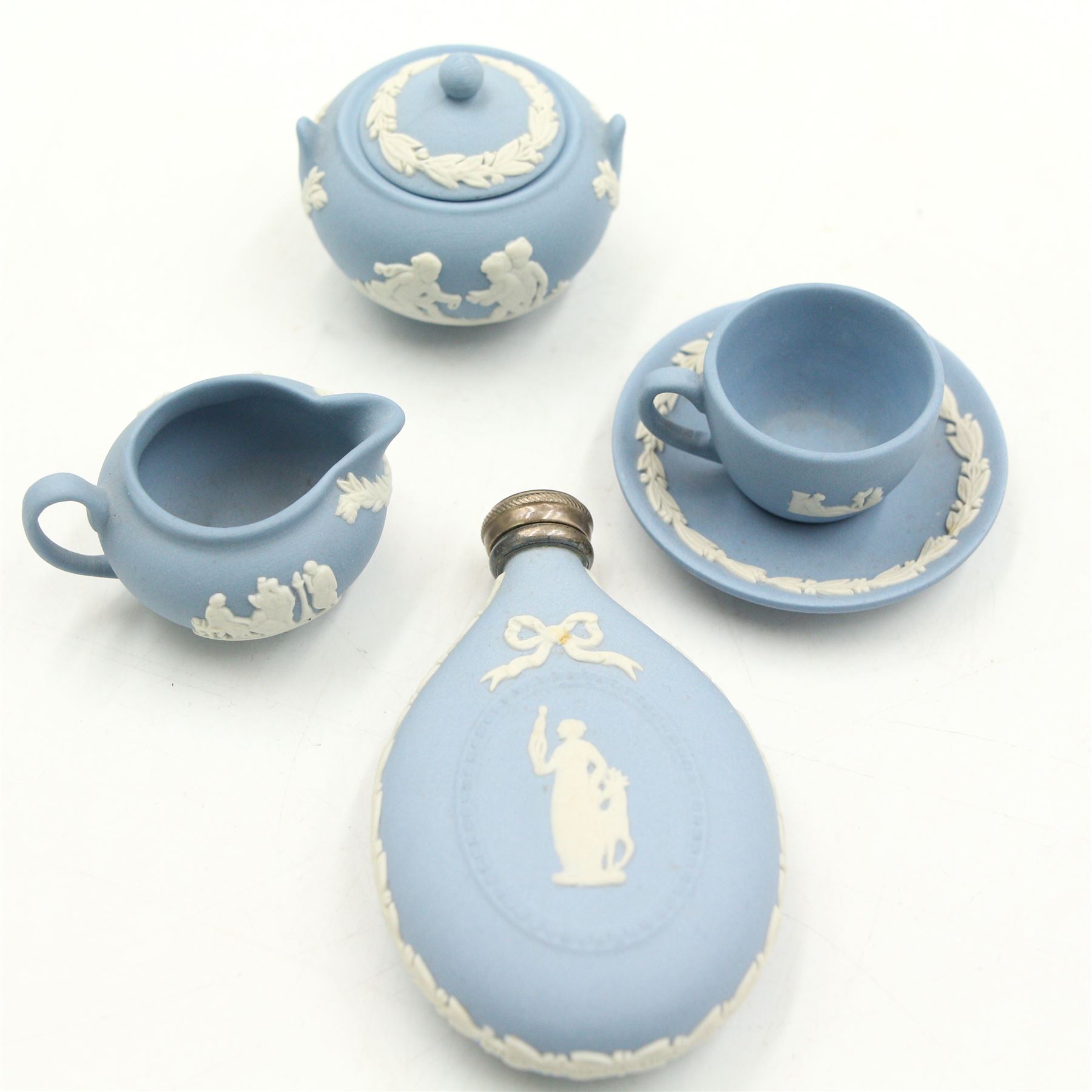 Wedgwood Jasperware miniature tea set for one, on a matched tray, oval scent bottle with silver cover, four caddy spoons, miniature bell, seven thimbles, together with a cased pair of portrait medallions of Josiah Wedgwood FRS and Thomas Bentley 