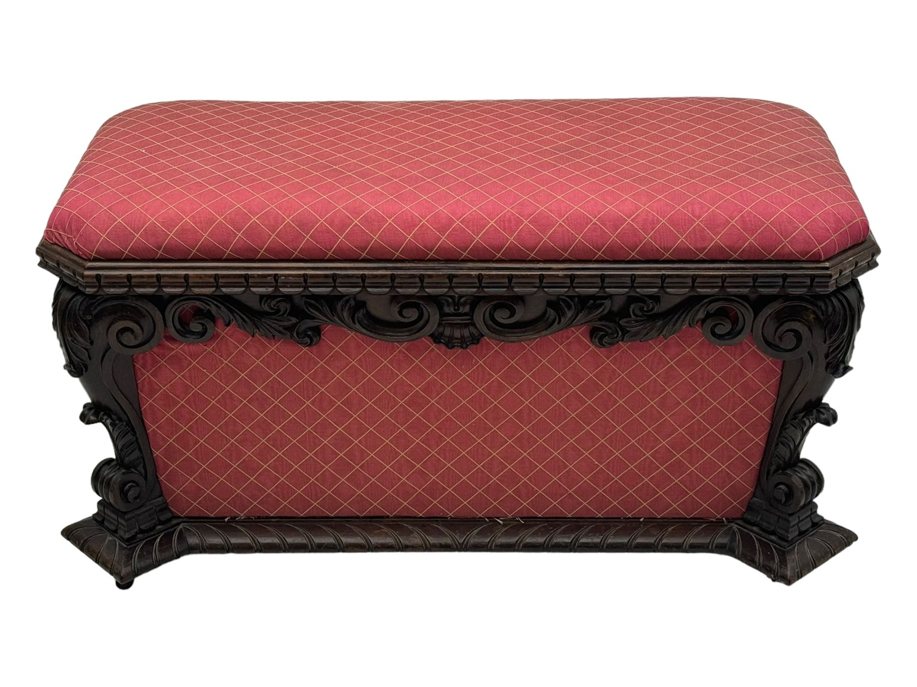 19th century rosewood and simulated rosewood ottoman footstool, tapering canted rectangular form enclosed by hinged lid, upholstered in red fabric, the frieze decorated with scrolling leaves, each corner with scrolled acanthus leaf supports, projecting shallow gadroon moulded edge 