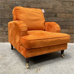 Armchair upholstered in orange velvet fabric