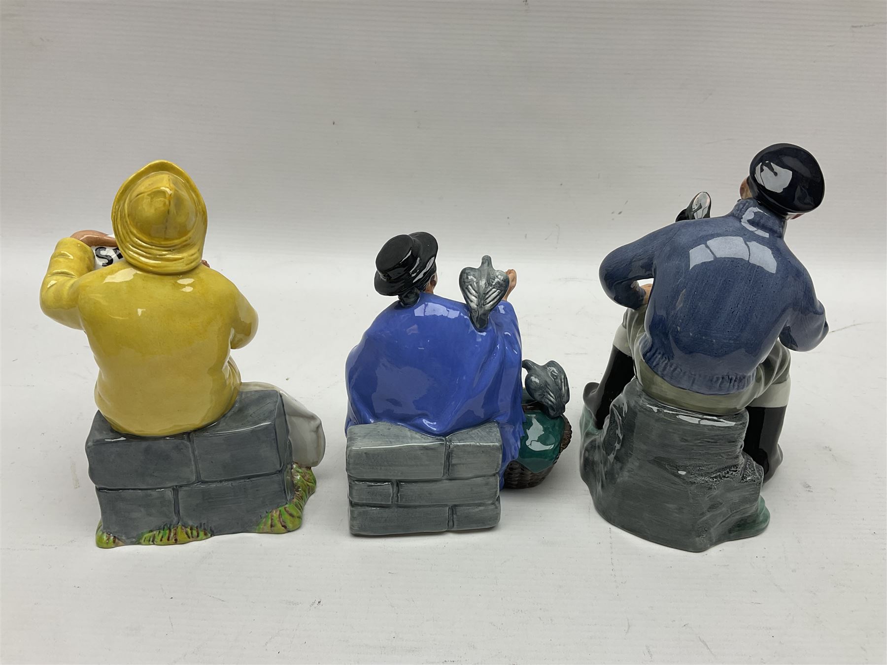 Three Royal Doulton figures, comprising Tuppence a Bag HN2320, The Boatman HN2417 and The Lobster Man HN2317