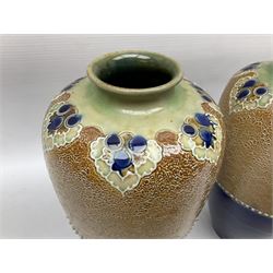 Pair of Royal Doulton Lambeth stoneware baluster vases, decorated in light relief with foliage, impressed mark beneath, H23cm