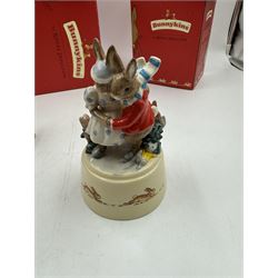 Two Royal Doulton Bunnykins music boxes, comprising Rocking Horse and Winter Waltz together with two Royal Doulton Bunnykins figures Once Upon a Time and Father, Mother & Victoria, all with original boxes  