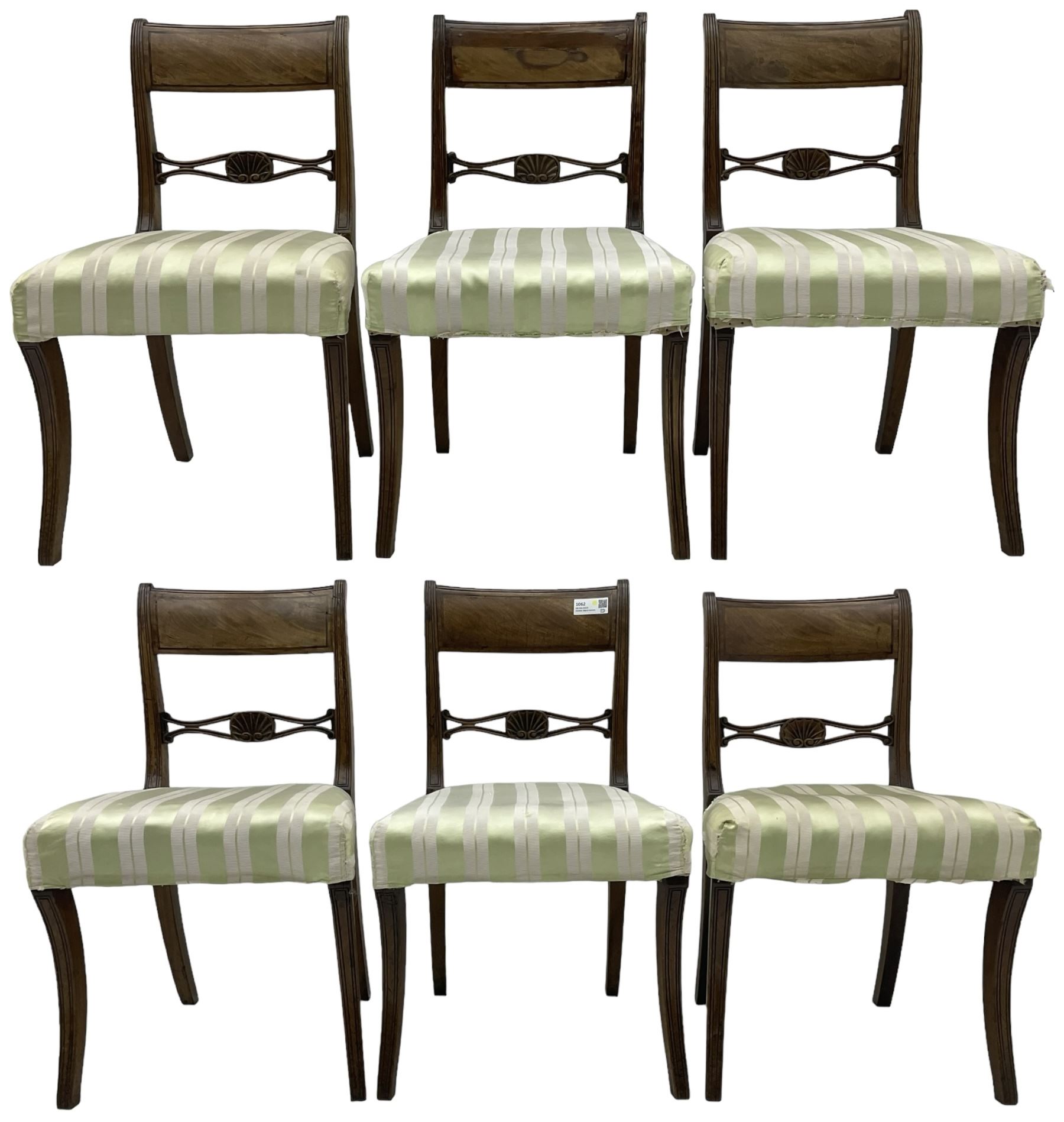 Set of six early 19th century mahogany dining chairs, bar cresting rail over pierced and shell carved middle rail, reed moulded uprights, upholstered seats on reed moulded sabre supports 