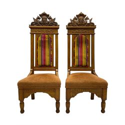 Set of six 20th century Carolean design oak high back chairs, the pediment carved with dragons and central Green Man mask with trailing foliage, the backs upholstered in striped fabric, on turned front supports