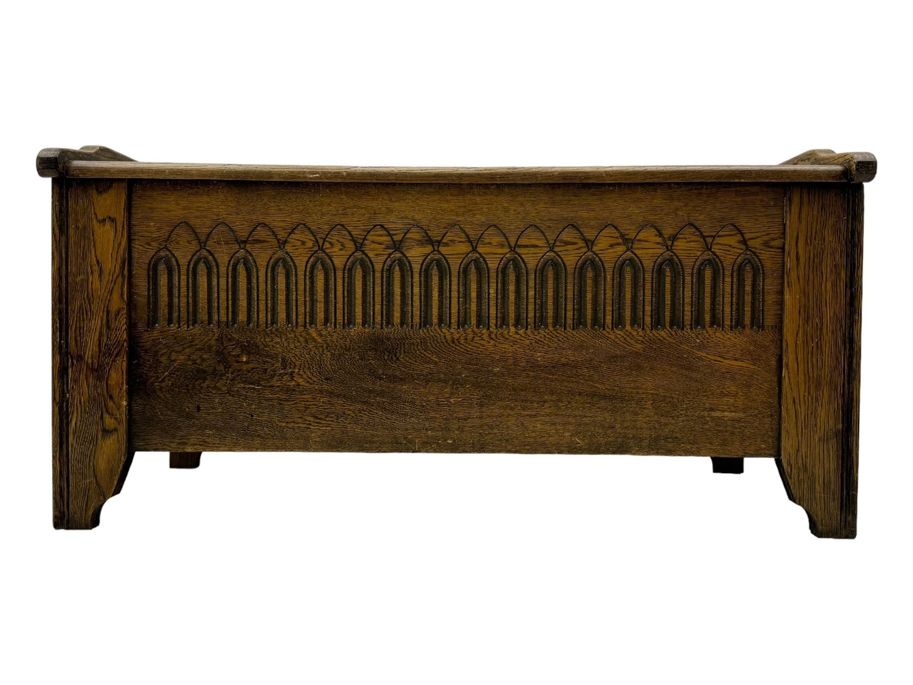 20th century oak coffer or blanket chest, rectangular hinged top over repeating Gothic arch carved front and shaped sides, constructed with pegged joints, on stile supports