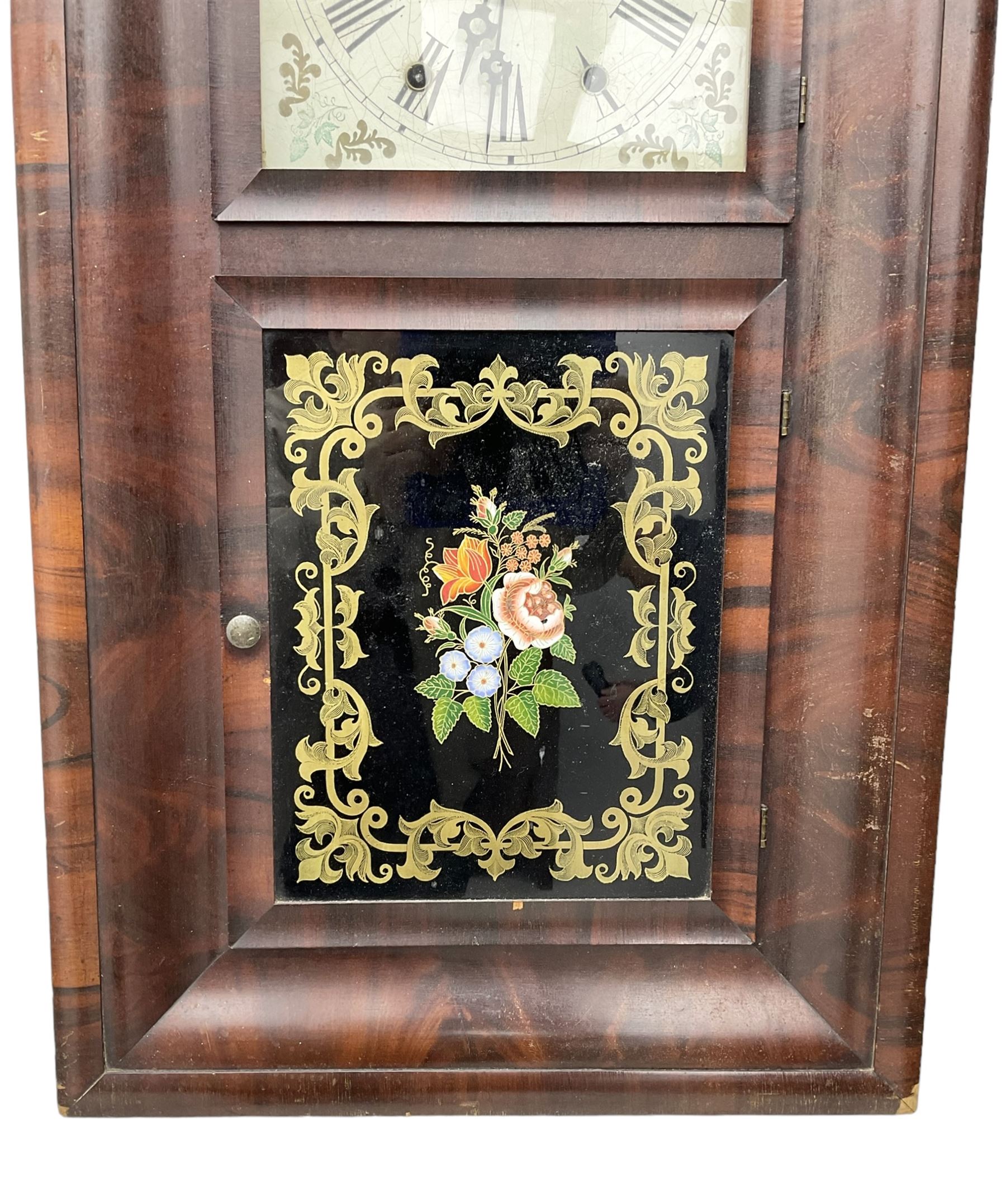 American - 19th century mahogany veneered 8-day ogee shelf clock, rectangular case with two glazed doors to the front, decorative glass tablet to the lower door with a depiction of flowers on a black background with a gold border, painted dial with Roman numerals, minute track, floral spandrels and Maltese cross steel hands, two train weight driven movement, striking the hours on a coiled gong. With the original Jerome trade label pasted on the inner back board of the case.