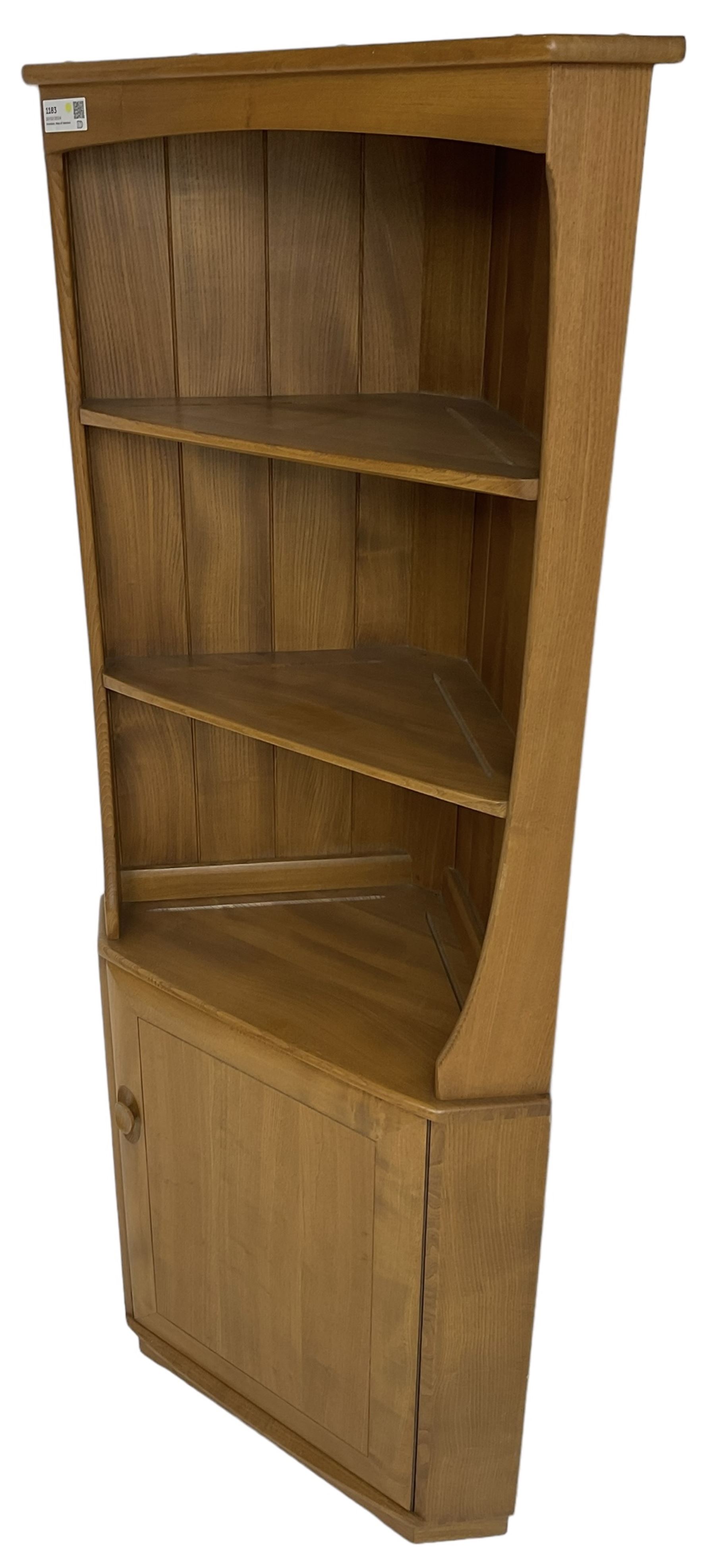 Ercol - mid-20th century '743C'  light elm corner cabinet, fitted with two open shelves over a single cupboard