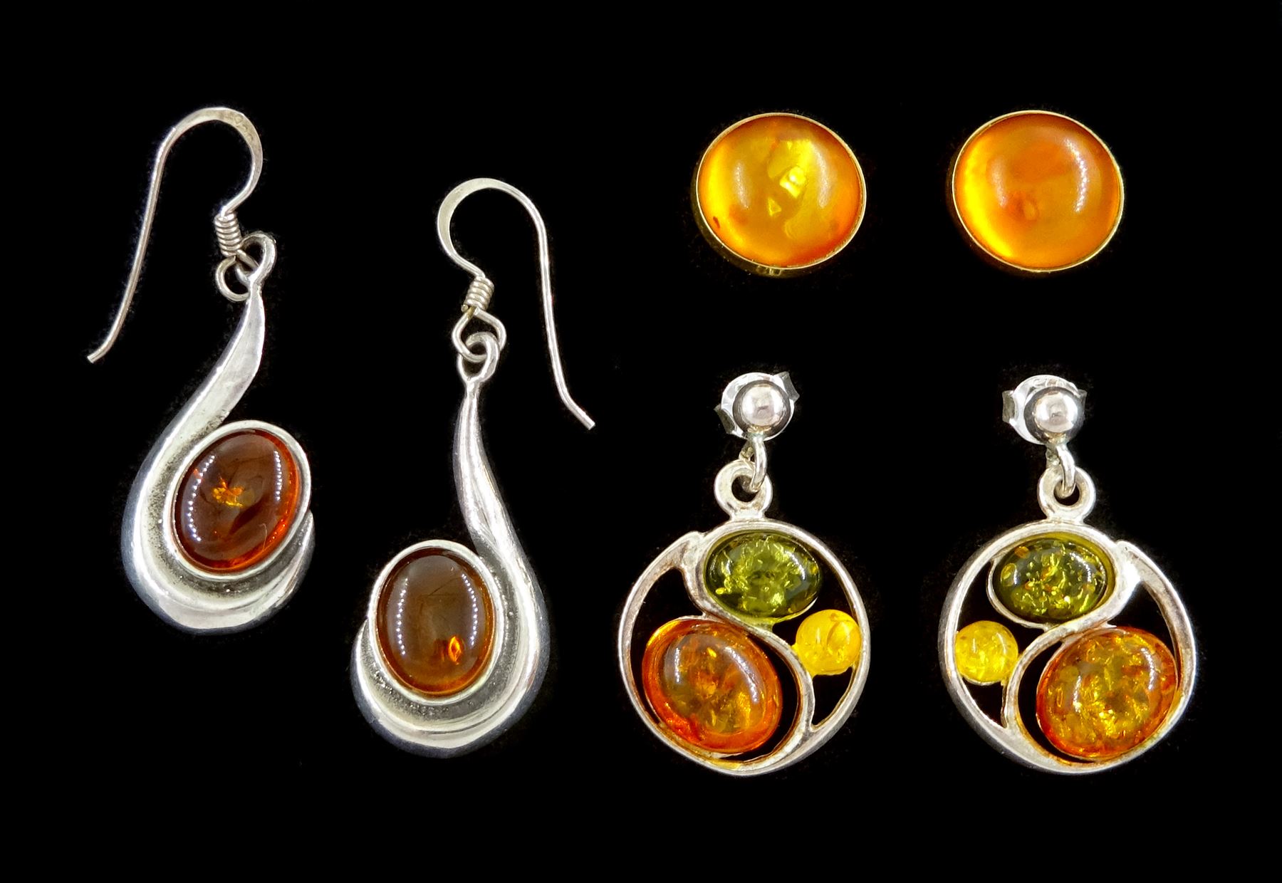 Pair of 14ct gold circular amber stud earrings, hallmarked and two pairs of silver amber pendant stud earrings, stamped 925