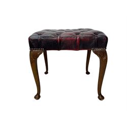 Chesterfield three-seat sofa, traditional shaped upholstered in deeply buttoned dark red leather; together with similar footstool 