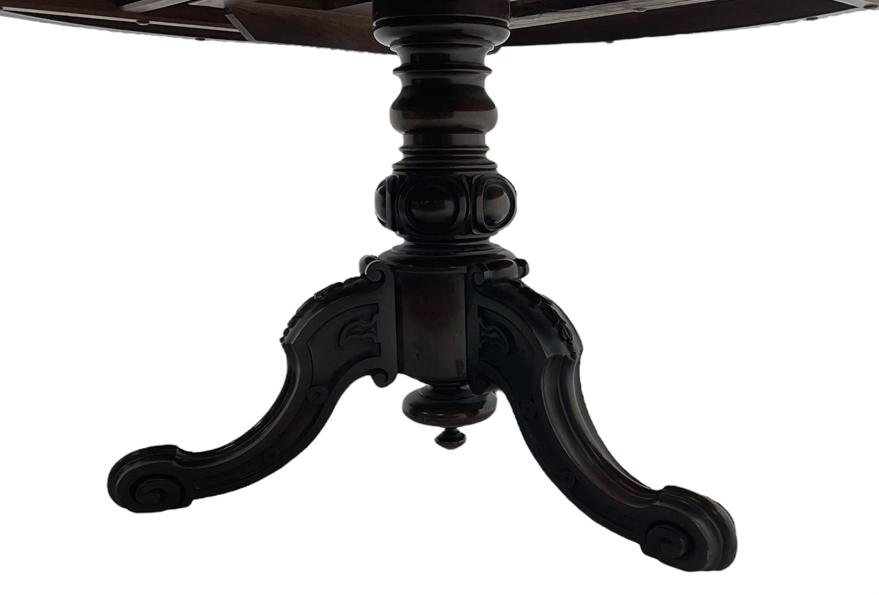 Victorian mahogany breakfast table, the circular tilt-top on carved pedestal, three moulded supports carved with bellflowers and scrolled terminals 