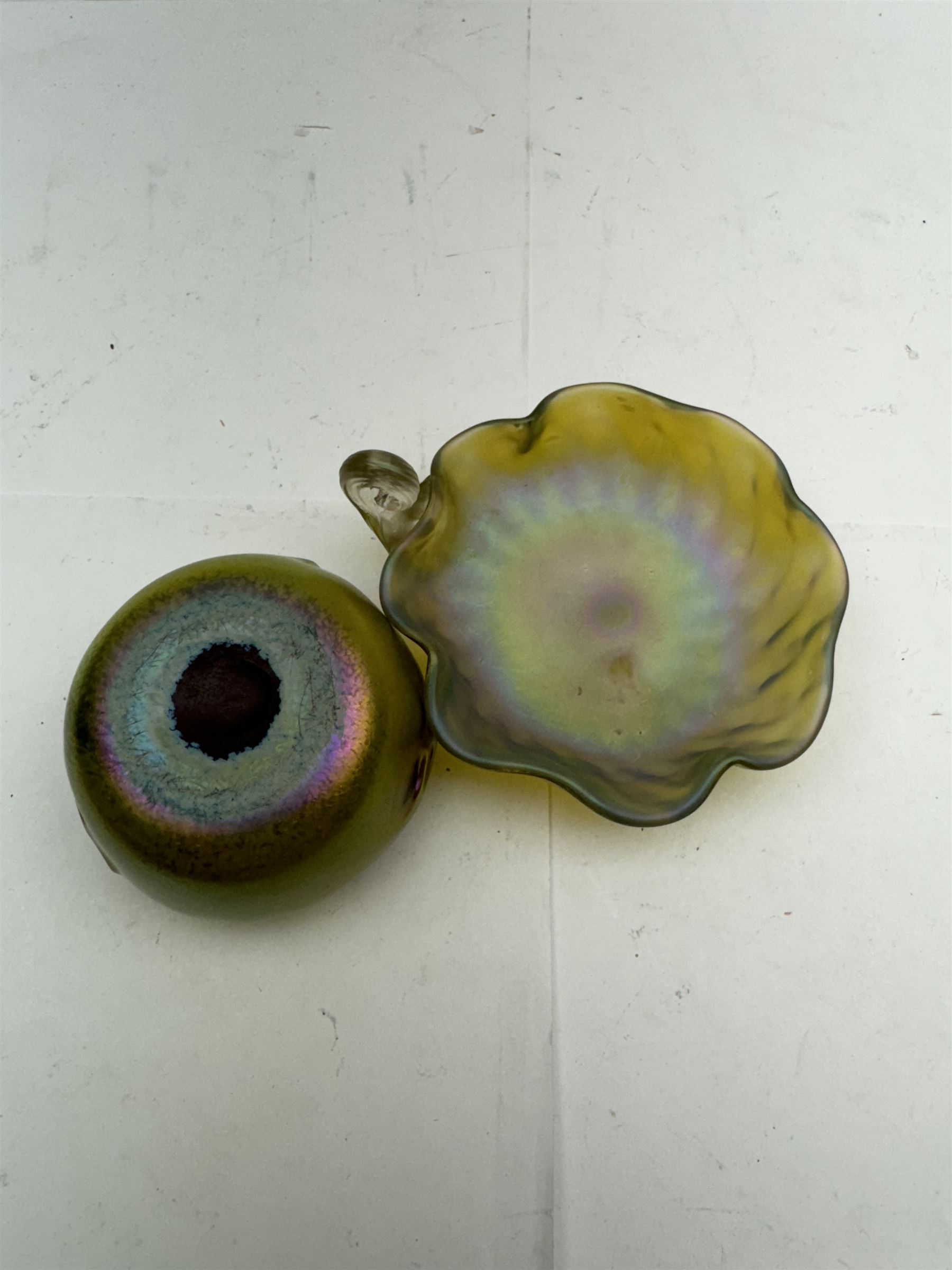 Two pieces of Austrian Art Nouveau glass, in the manner of Louis Comfort Tiffany, to include a fluted bon bon dish, with pearlescent irisdescent finish and scrolling shell handle and a small circular vase, with pinched decoration and green iridescent finish, bob bon dish D11cm