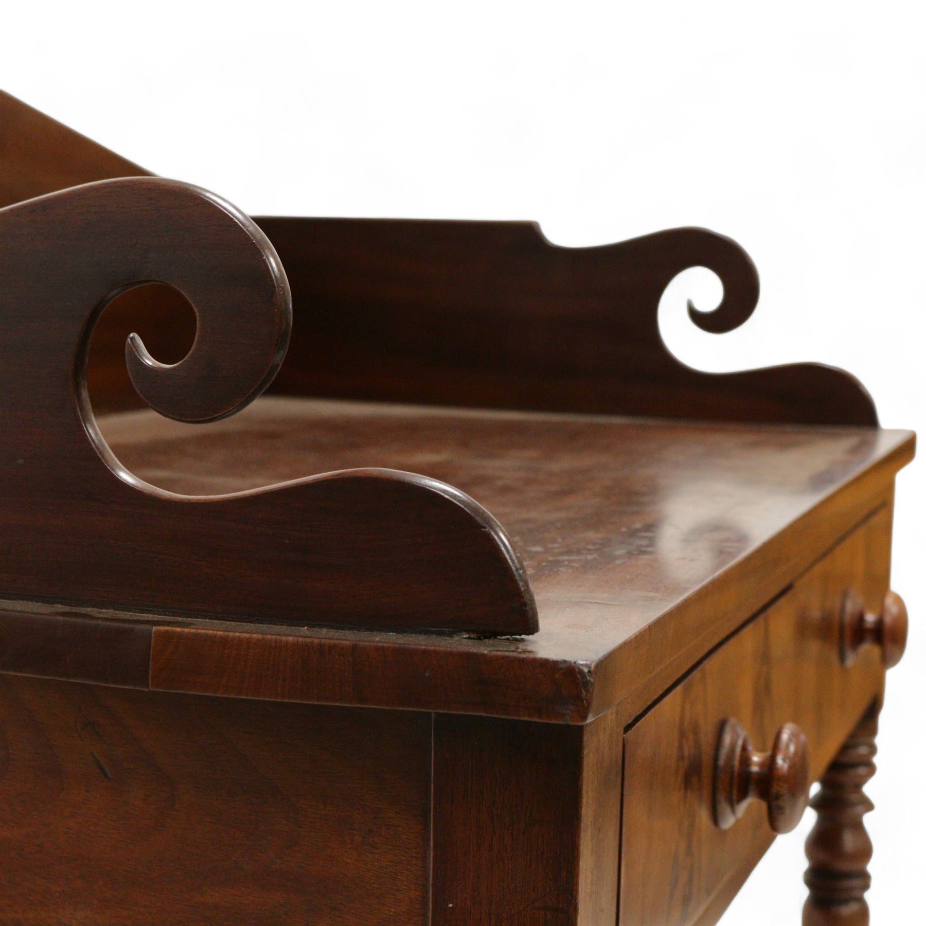 Early Victorian mahogany wash stand, pointed and sloped arch back with shaped and pierced scroll returns, rectangular top over two drawers, on turned supports united by undertier 