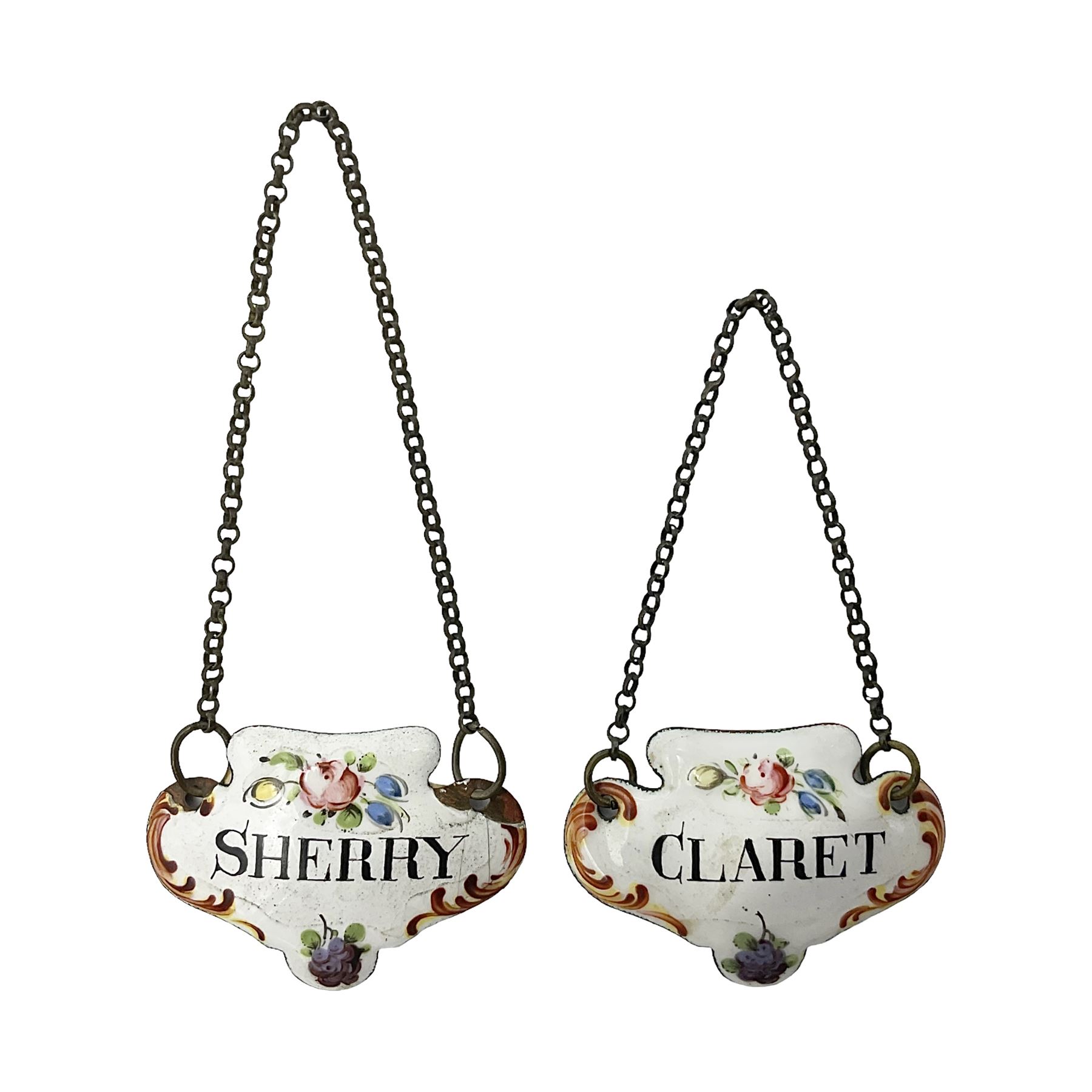 Two late 18th/early 19th century enamel wine labels, each of shaped form, titled 'CLARET', and 'SHERRY' and decorated with floral sprigs and scroll detail upon a white ground, each with suspension chain, each approximately H3.5cm W5cm