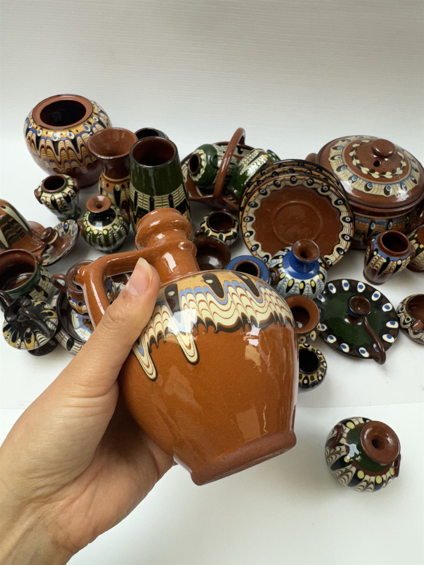 Collection of slipware, including miniature vases, baskets, candlesticks jugs etc 