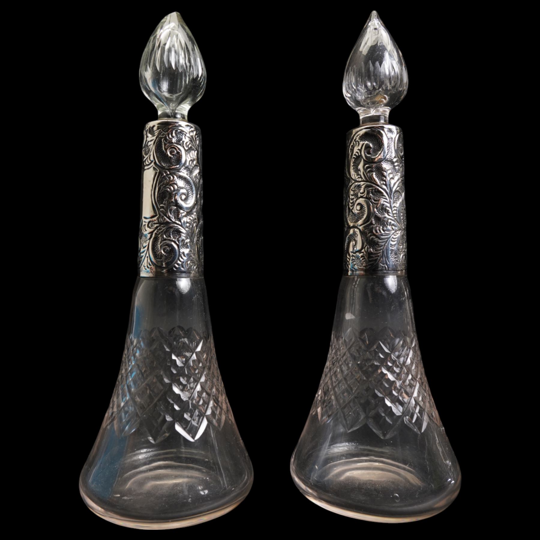 Pair of silver mounted glass scent flasks H20cm London 1916 Maker J H Worrall, Son & Co Ltd, , another matching of tapering form, a small scent flask in outer silver sleeve Birmingham 1902 and various silver mounted glass scent flasks, vases etc  (11)