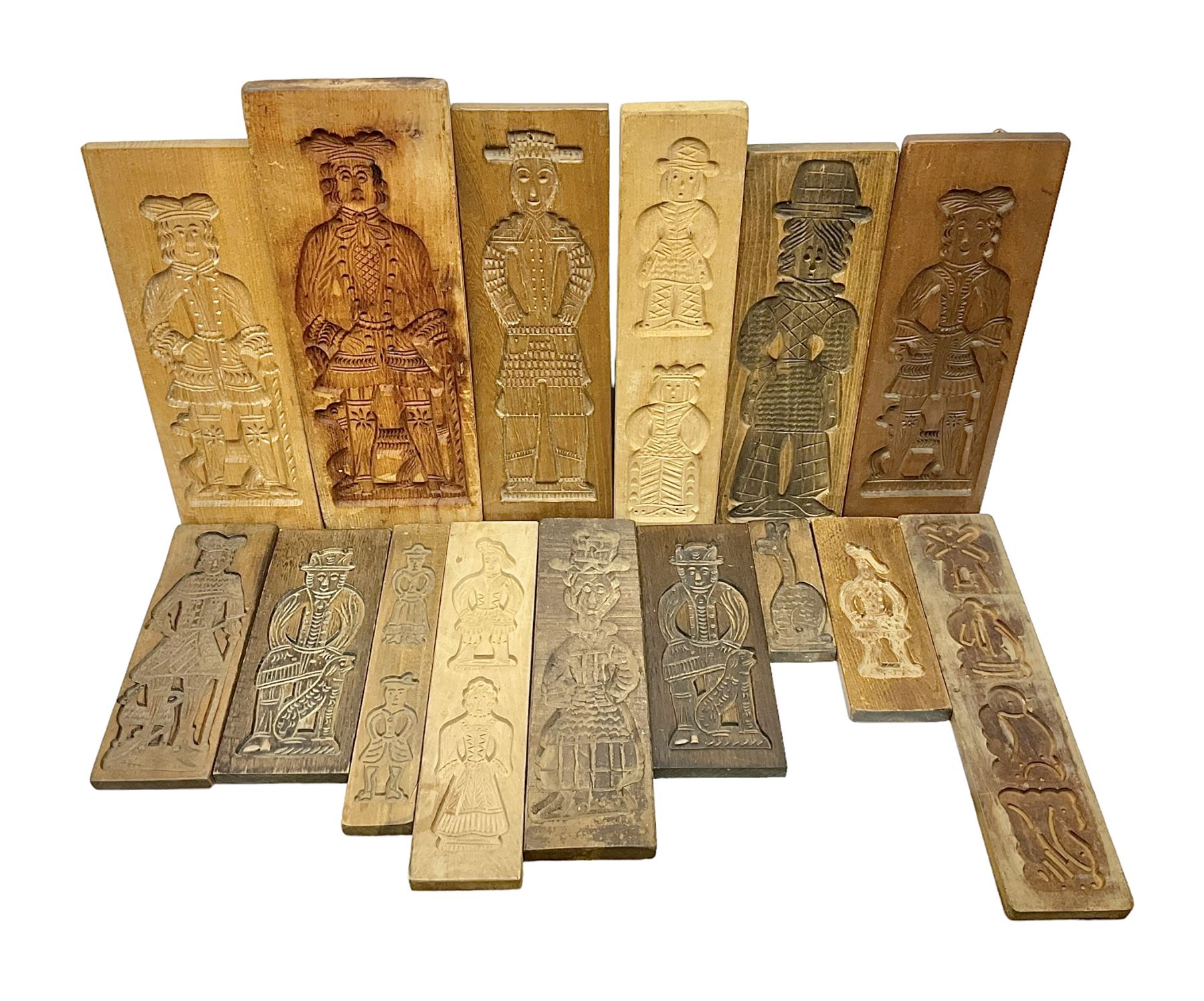 Collection of 20th century beech and other hardwood Dutch folk art Speculaasplank or biscuit moulds, most examples typically carved with figures in traditional dress, tallest H52cm