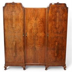 Early to mid-20th century figured walnut triple wardrobe, enclosed by quarter-matched vene...