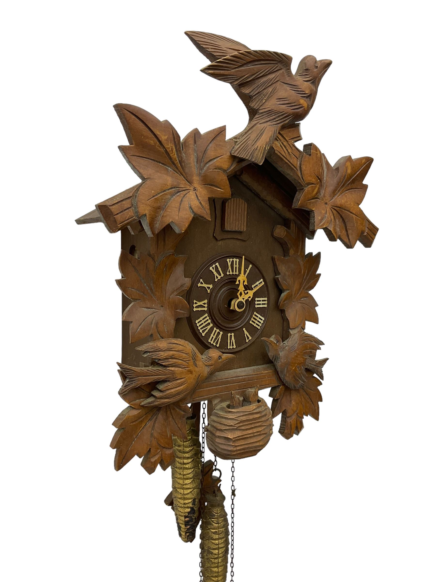 German 1960's cuckoo clock with automata - traditional styled case and dial with a cuckoo sounding the hours and half-hours, twin chain driven movement and automata feature of two carved cuckoos to the front of the case simultaneously moving as the hours are struck. With weights and pendulum.  